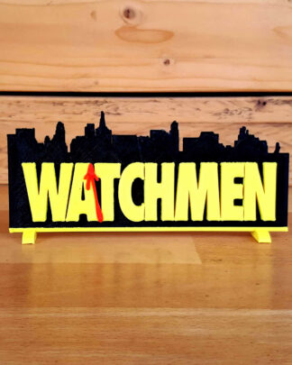 Logo 3D WATCHMEN jaune et noir posé sur un plan de travail en bois